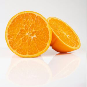 Vibrant orange slices showcasing freshness and juicy texture on a white background.